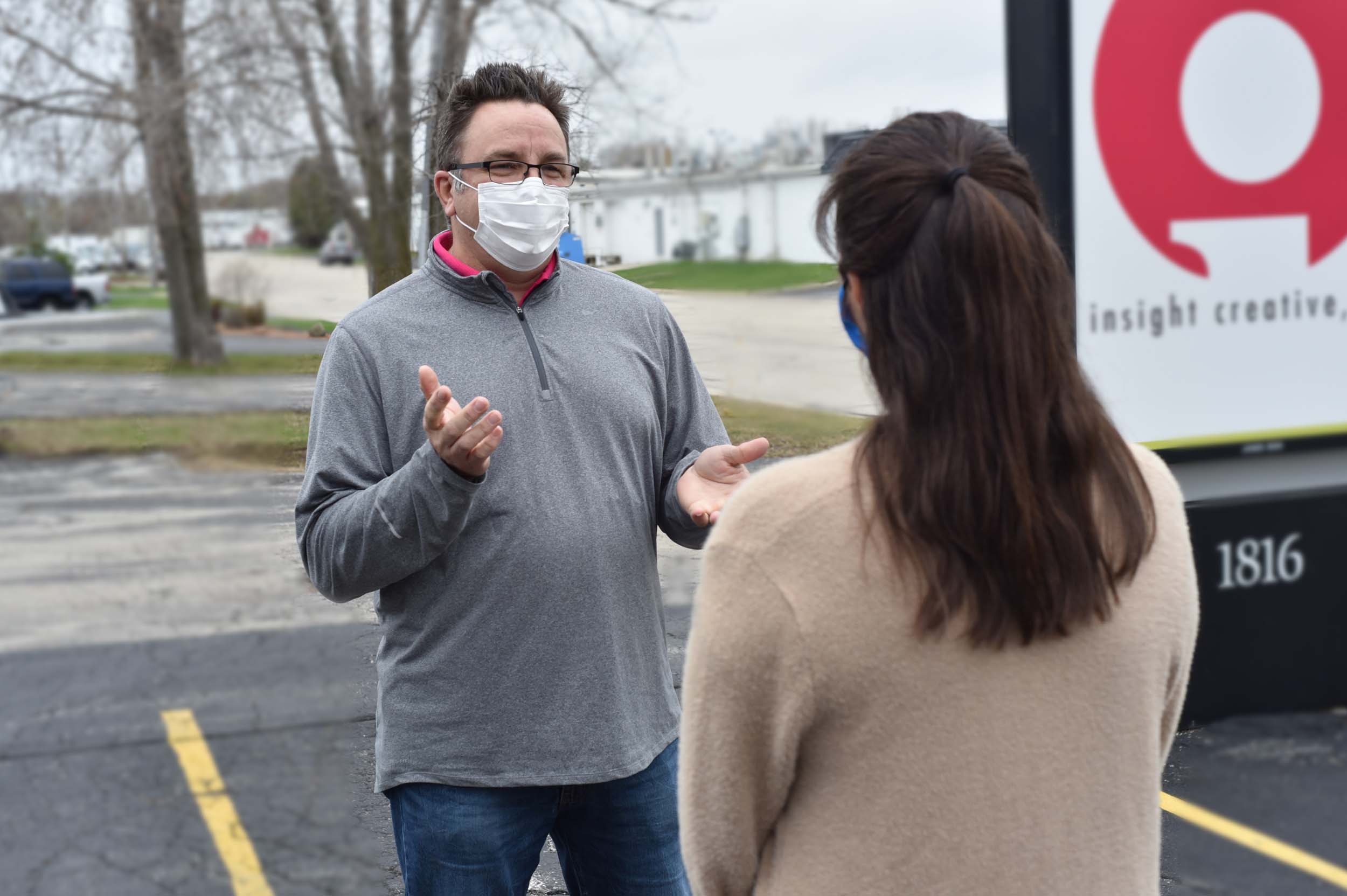 Brian talking with woman outside of the Insight Creative, Inc. office